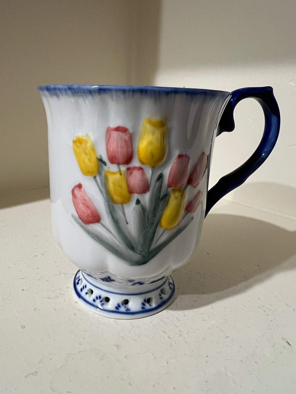 This is a Delftware Royal Twickel porcelain mug featuring raised tulip design